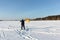 Man man lifting a kite from the snowy surface of a reservoir, Novosibirsk, Russia