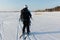 Man man lifting a kite from the snowy surface of a reservoir, Novosibirsk, Russia