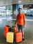 Man With Many Luggage Bags Is Waiting For Airplane In Airport Terminal