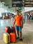 Man With Many Luggage Bags Is Waiting For Airplane In Airport Terminal