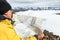 Man with map exploring wilderness on trekking adventure.