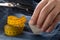 Man marking line with tailor`s chalk on jeans denim fabric with scissors and measuring tape on blue jeans denim close up - jeans