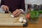 Man in maroon sweater slicing mushrooms