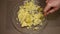 Man mashes potatoes in a glass bowl