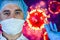 Man in a mask and protective gloves on the background of the image of a coronavirus. Doctor with a vaccine and a syringe