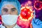 Man in a mask and protective gloves on the background of the image of a coronavirus. Doctor with a vaccine and a syringe