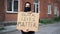 Man in mask stands with cardboard poster in hands - Black Lives Matter