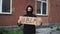 Man in mask stands with cardboard poster in hands - Black Lives Matter