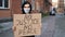 Man in mask stands with cardboard poster in hands - NO JUSTICE NO PEACE