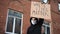 Man in mask stands with cardboard poster in hands - WHITE LIVES MATTER