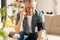 A man measures blood pressure at home with a blood pressure cuff and a tonometer. A man calls a doctor on a mobile phone