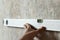 A man measures on the wall with a ruler, a tape measure, a level, marks the markers. The concept of construction work, repair with