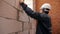 Man measuring length of window in building