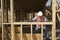 Man Measuring Level Of A Wooden Beam