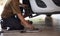 Man mechanic technician worker installing car wheel maintenance in auto service. Hand of mechanic man repair disk brake and car