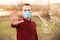 Man with medical face mask showing stop gesture outdoor. People, healthcare and medicine concept