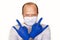 Man in medical gloves and a mask shows the rock sign.