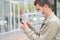 A man in a medical mask dials a number in a mobile phone, close-up