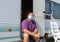 Man in a medical mask next to a tourist trailer. concept of travel during the pandemic. mode of permanent wearing of a protective