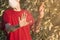 A man in a medical mask shows Stop gesture to a tree flowers, an allergen