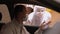 Man in a medical mask talking to a doctor in a protective suit sitting in car.