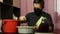 A man in a medical mask uses his hands to knead blue grapes taken from a bunch. Making homemade wine during an epidemic