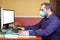 Man with medical mask  working in house. Teleworking concept