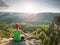 Man meditates in yoga in mountains above wild nature at sunset. Concept of meditation, spirituality and soul balance