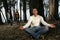 Man meditating in forest