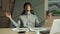 Man meditating in office coping with stress. Business executive doing yoga at desk in a modern office