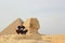 Man meditation with Egypt pyramids and sphinx view