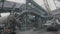 A man at a metallurgical plant. A worker walks through a large factory. Massive metal structures at a metallurgical