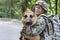 Man in military uniform with German shepherd dog