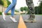 Man in military uniform and young woman separated by yellow line on road