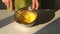 Man mixing white sugar and egg in a stainless bowl