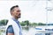 Man with model cut hair and bearded goatee. Portrait of young man with yacht. Man profile on the river bank.