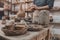 Man molding clay to make ceramics with his hands, Artisan working in his workshop, Selective Focus