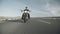 Man on motorbike rides along highway in helmet and sunglasses, drives ahead, front view. Biker rides road on motorcycle