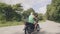 Man motorbiker riding on motorcycle on mountain road on green rainforest landscape. Adult man driving on motorbike while