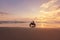 Man And Motorcycle On Ocean Beach At Beautiful Tropical Sunset. Biker Silhouette On Motorbike.