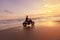 Man And Motorcycle On Ocean Beach At Beautiful Tropical Sunset. Handsome Biker On Motorbike.