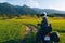 Man motorcyclist ride touring motorcycle. Alpine mountains on background. Biker lifestyle, world traveler. Summer sunny sunset day