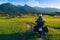 Man motorcyclist ride touring motorcycle. Alpine mountains on background. Biker lifestyle, world traveler. Summer sunny sunset day