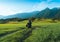 Man motorcyclist ride touring motorcycle. Alpine mountains on background. Biker lifestyle, world traveler. Summer sunny sunset day