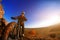 Man on mountain bike on the background of beautiful sunset. Bicycle wheel closeup.