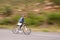 Man, mountain bike and cycling on road in speed for nature adventure or outdoor extreme sports. Male person or cyclist