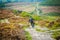 Man mountain biking on Burbage edge near to Hathersage in the Derbyshire Dales of the Peak District