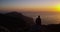Man, mountain top and view of sunset, ocean and relax with peace, thinking and memory on hiking adventure. Person, hill