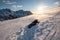 Man mountaineer climbing and crawling on snow mountain peak with sunshine in the evening at Ryten Mount