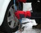 Man mounting snow chains in the car tire in winter